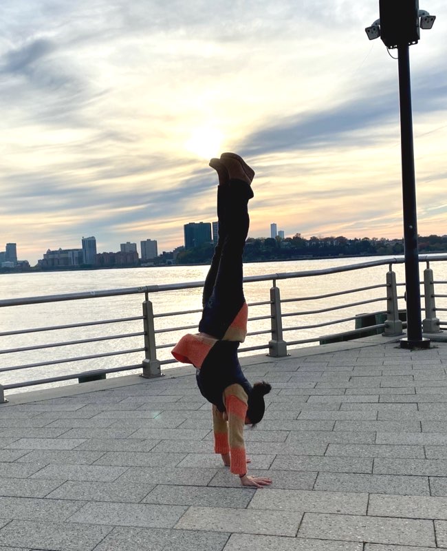 Lisa Weinert doing handstand in front of water