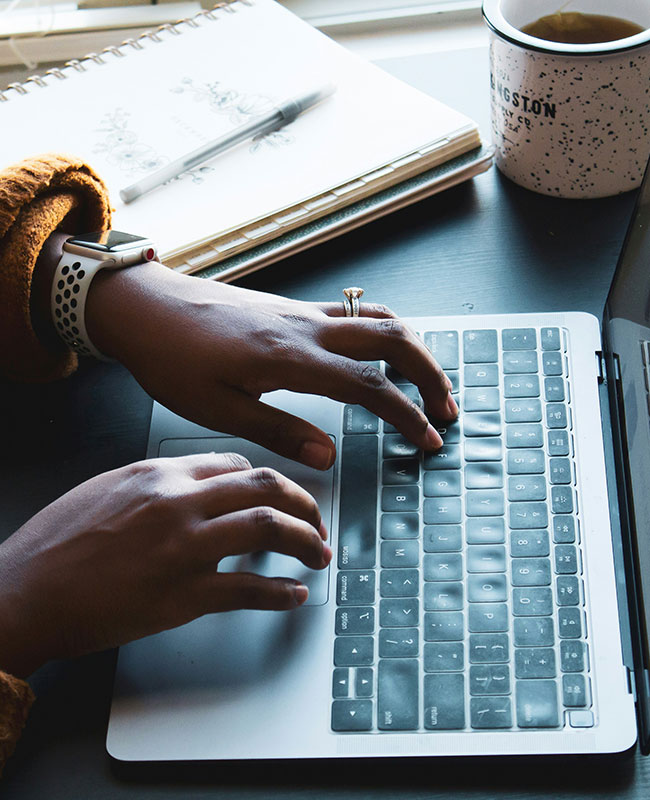 Woman writing on laptop